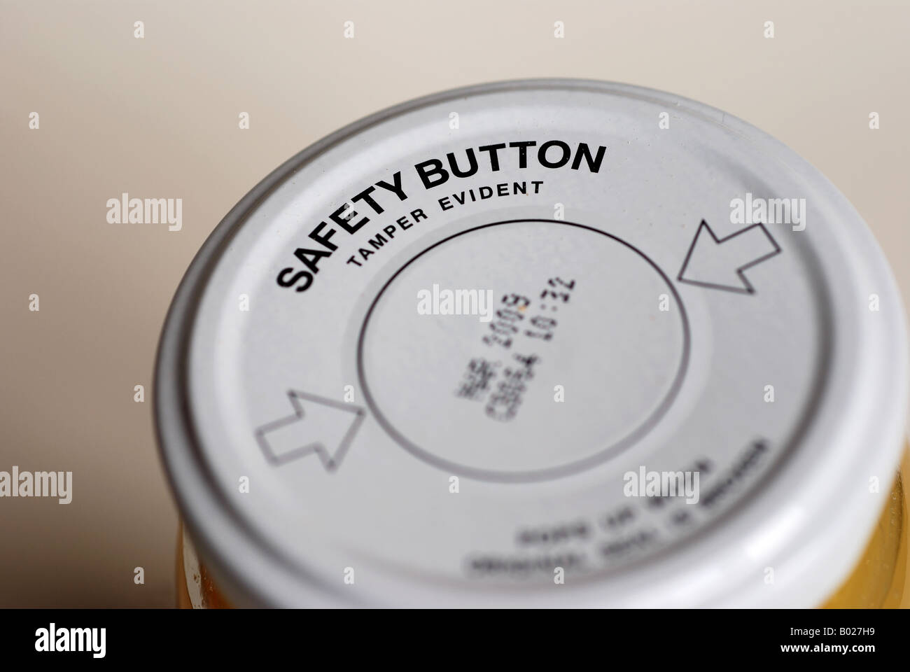 Tamper evident safety button on Sainsbury`s basics lemon curd jar, UK